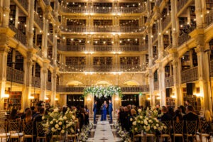 Elegant wedding reception inside George Peabody Library featuring historic architecture, romantic lighting, and timeless Baltimore wedding style.